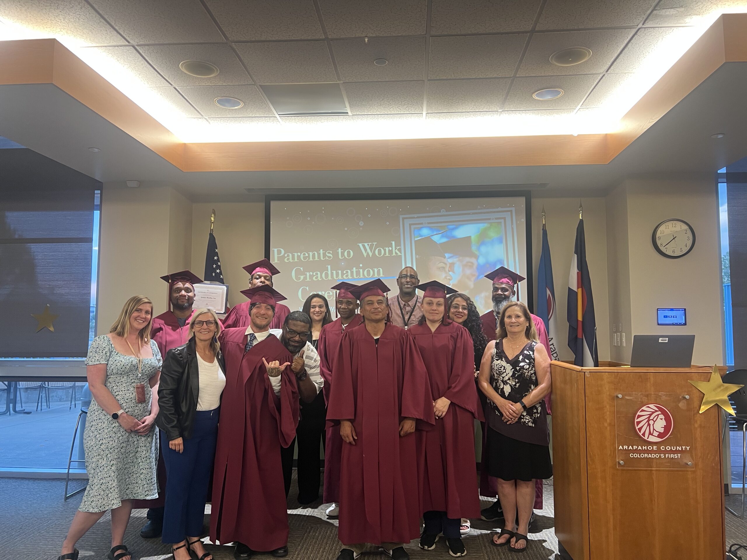 2025 group of Parents to Work program participants in their caps and gown for an accomplishment ceremony